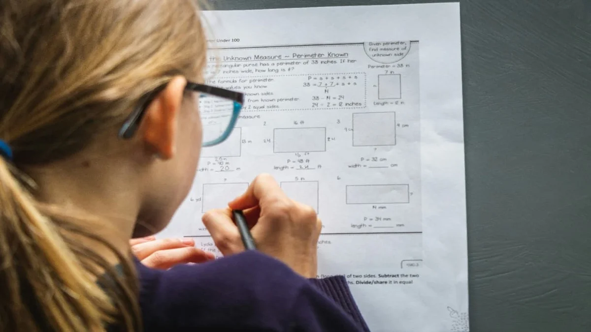 IGCSE maths student in the UAE revising past papers at a home study desk